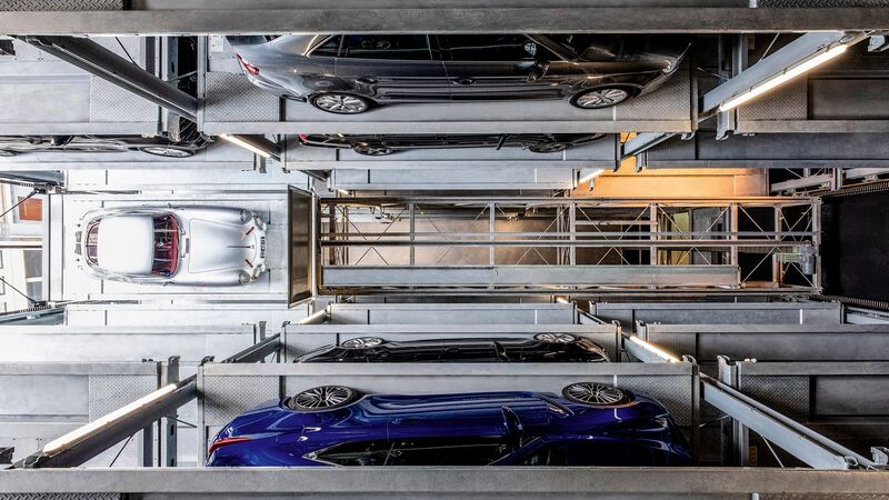 The car is parked on a parking pallet in a multi-storey car park system